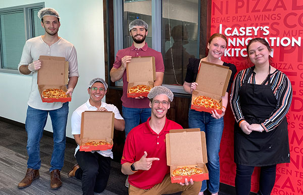 interns with pizzas