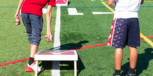 people playing bags game