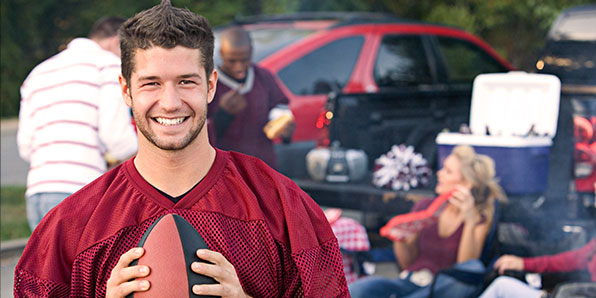 person holding football