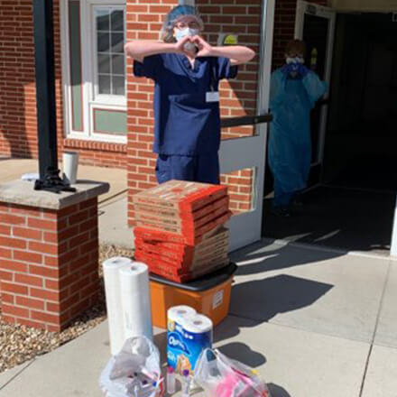 Nursing home staff with Casey's pizza and donations